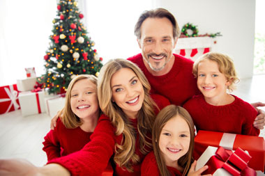 Happy family celebrating Christmas together, representing first-time homebuyer programs in New York and Pennsylvania