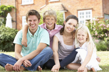 Happy family enjoying outdoor time in front of home, ideal for USDA rural housing loans in Upstate NY and Western PA